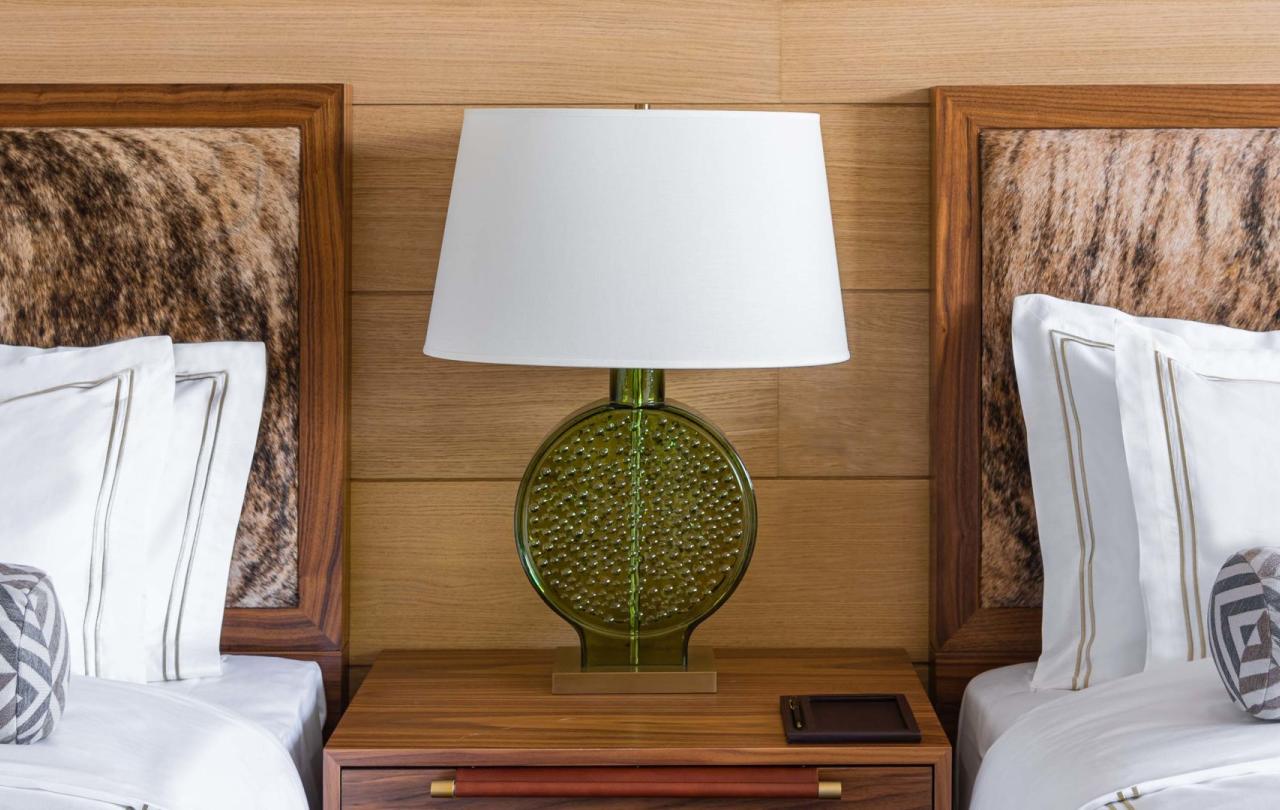 A night stand dividing two queen beds in a room at Viceroy Kopaonik Serbia